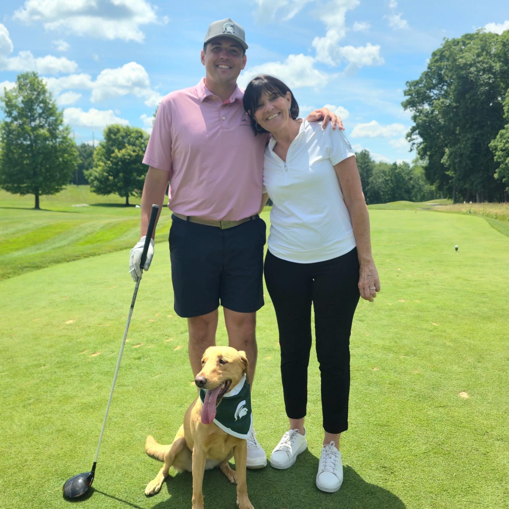 Zeke the WonderDog on the golf course with fans