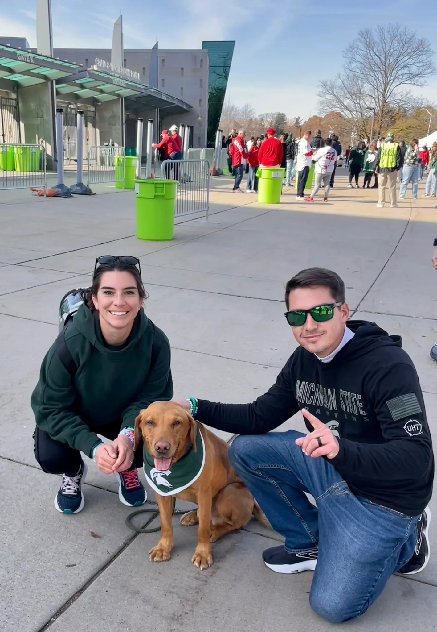 Tyler and Amanda Hathaway posing with Zeke the WonderDog outside Spartan Stadium
